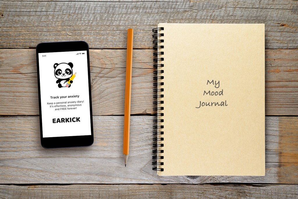 Tracking anxiety: Screenshot of the Earkick selfcare companion app and a physical mood journal on a table.