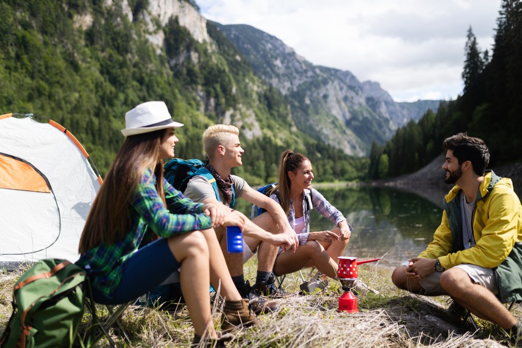 Group of friends trekking, camping and recovering in nature during a weekend to fully disconnect from work
