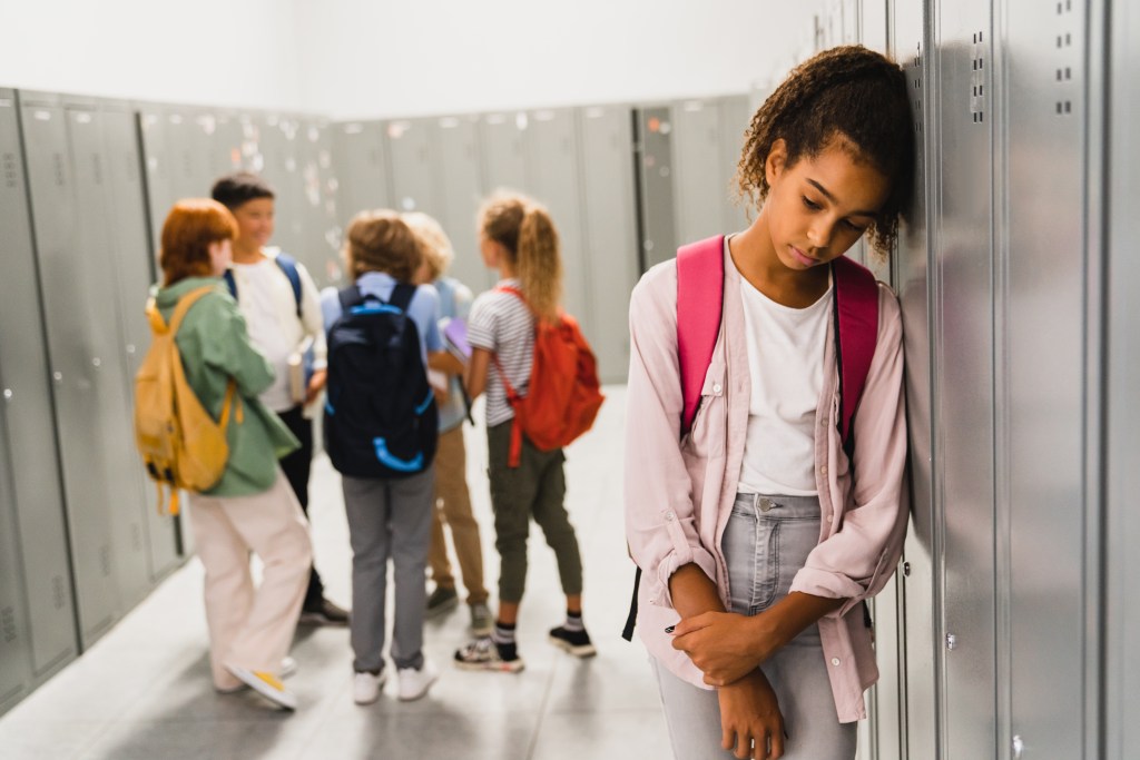 Youth mental health drivers at school: girl experiencing bullying at school, feeling lonely, sad and misunderstood