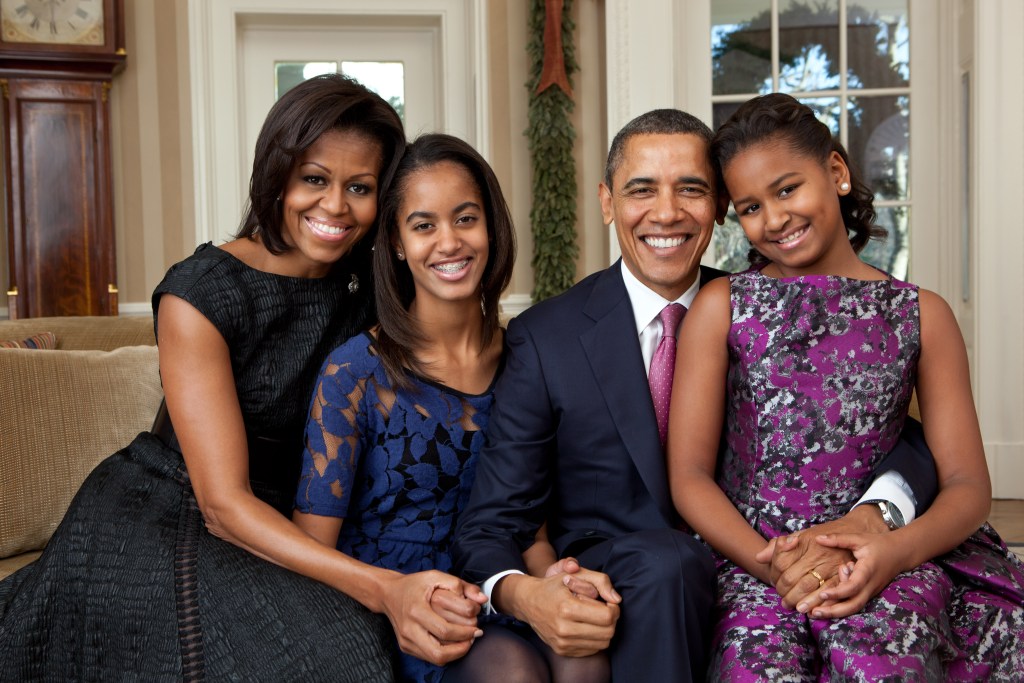 First Lady Michelle Obama, President Barack Obama and daughters Malia and Sasha sit for a family portrait in the Oval Office, Dec. 11, 2011. 