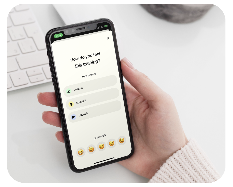 Closeup of the right hand of an Earkick member holding a smartphone and using the journaling/self-check-in feature of the app