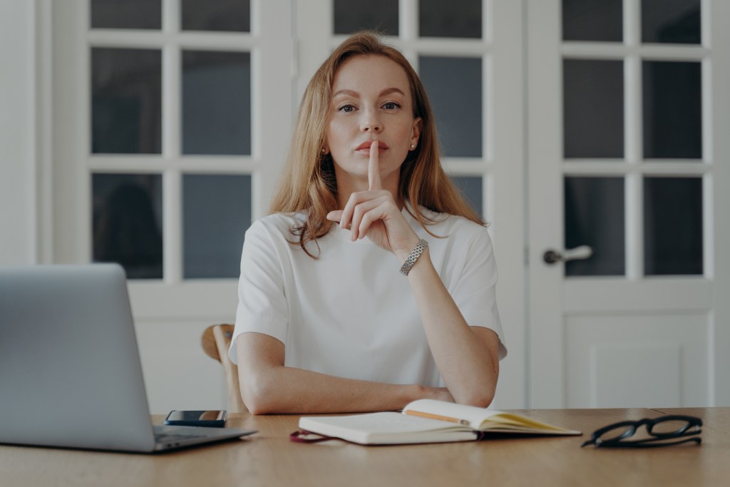 Young businesswoman working from home facing the health-privacy paradox. On one hand she wants to get timely and personalized mental health support but on the other hand she wants to protect her privacy.