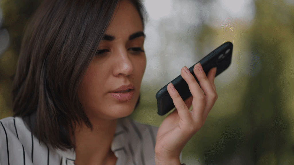Young Hispanic woman speaking into her anxiety journal app to reduce daily stress, worries and discomfort.