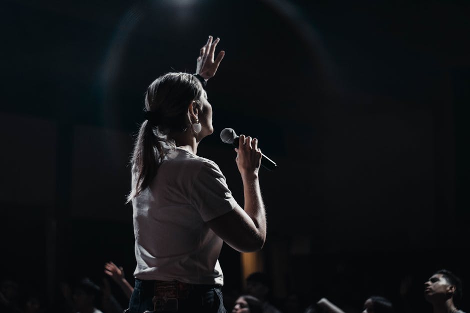 Young woman singing in front of an audience. She overcomes performance anxiety by turning every mistake into a learning opportunity