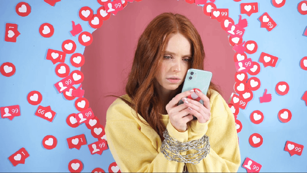 Perfectionist pressure: Young red-haired female influencer, sad, chained to social media and addicted to likes
