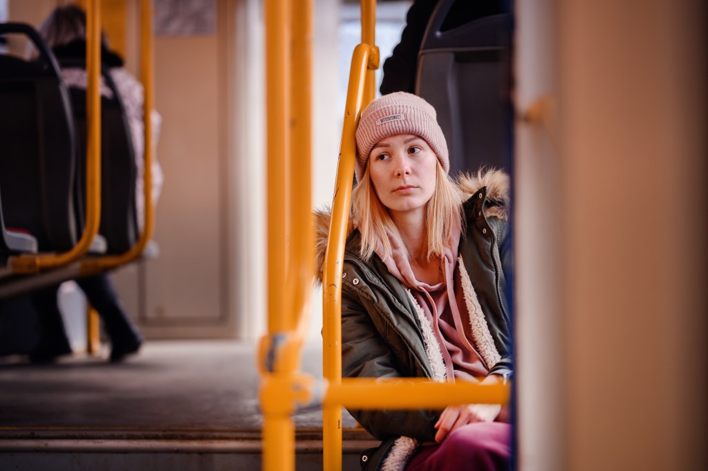 Loneliness quotes: Young woman sitting in a bus feeling lonely among people