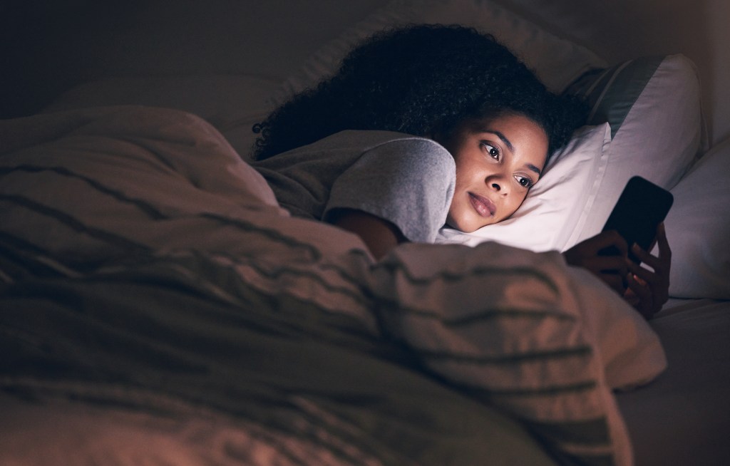 How AI helps mental health: Woman interacting with AI therapist app because she can't sleep and needs relief from rumination