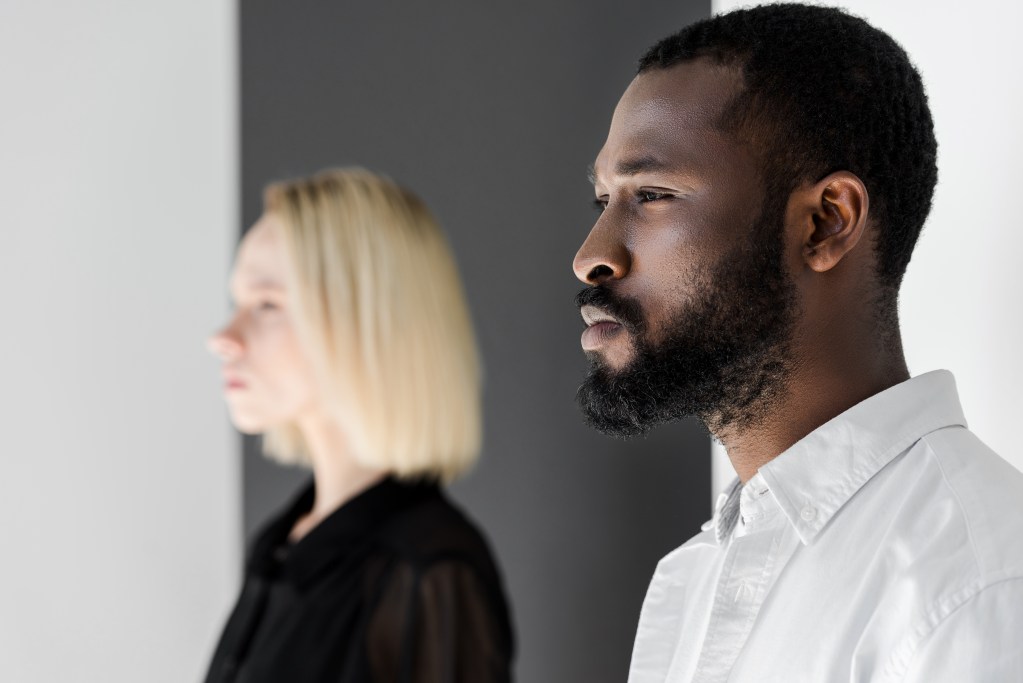 Signs of an emotionally unavailable man or woman? Side view of distant couple looking away from each other