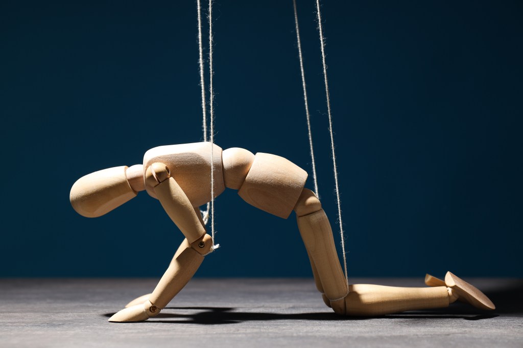 7 Stages of Trauma Bonding: marionette representing concept of control over people