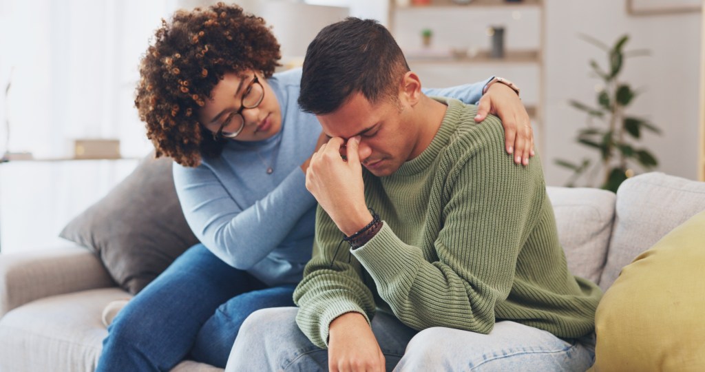 Woman comforting a man who’s in crisis