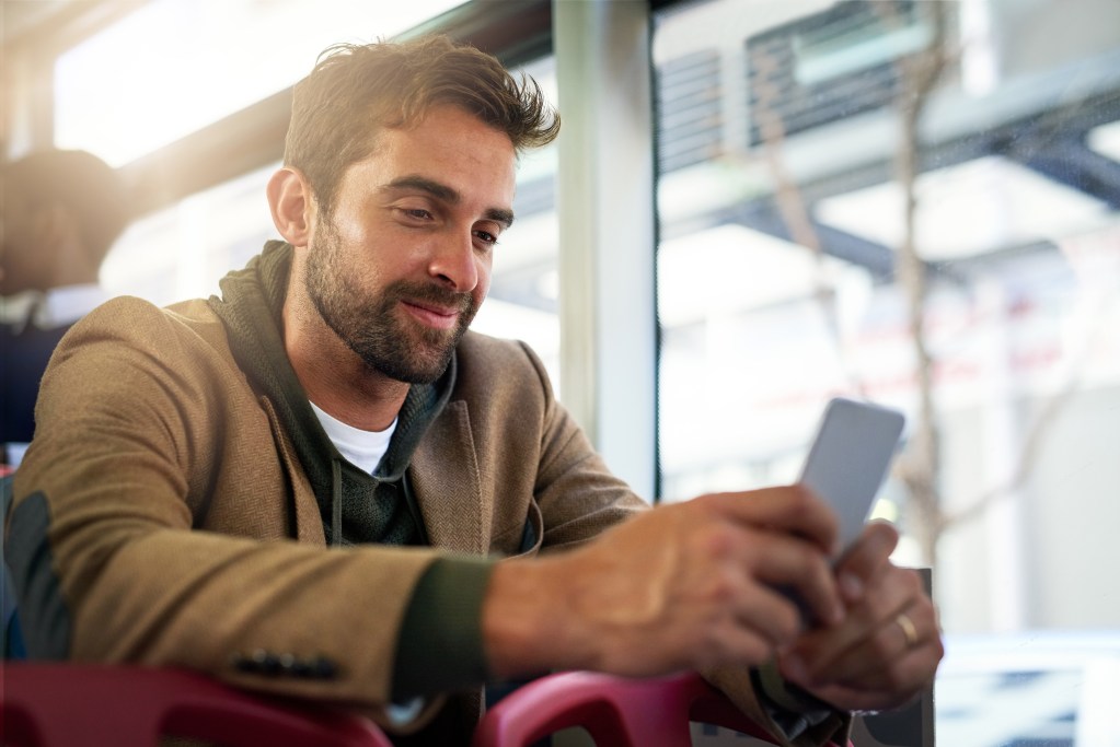 Things to talk about with your crush: Man sending a text while on the bus.