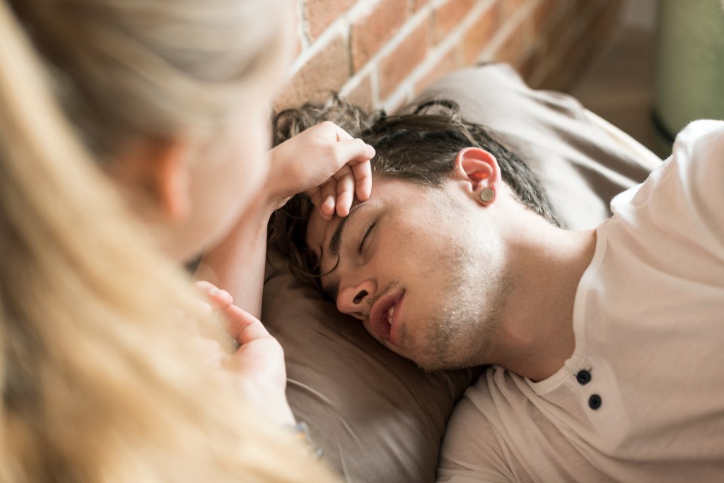 Chronic illness quotes: Friend consoling male patient struggling with pain and fever 