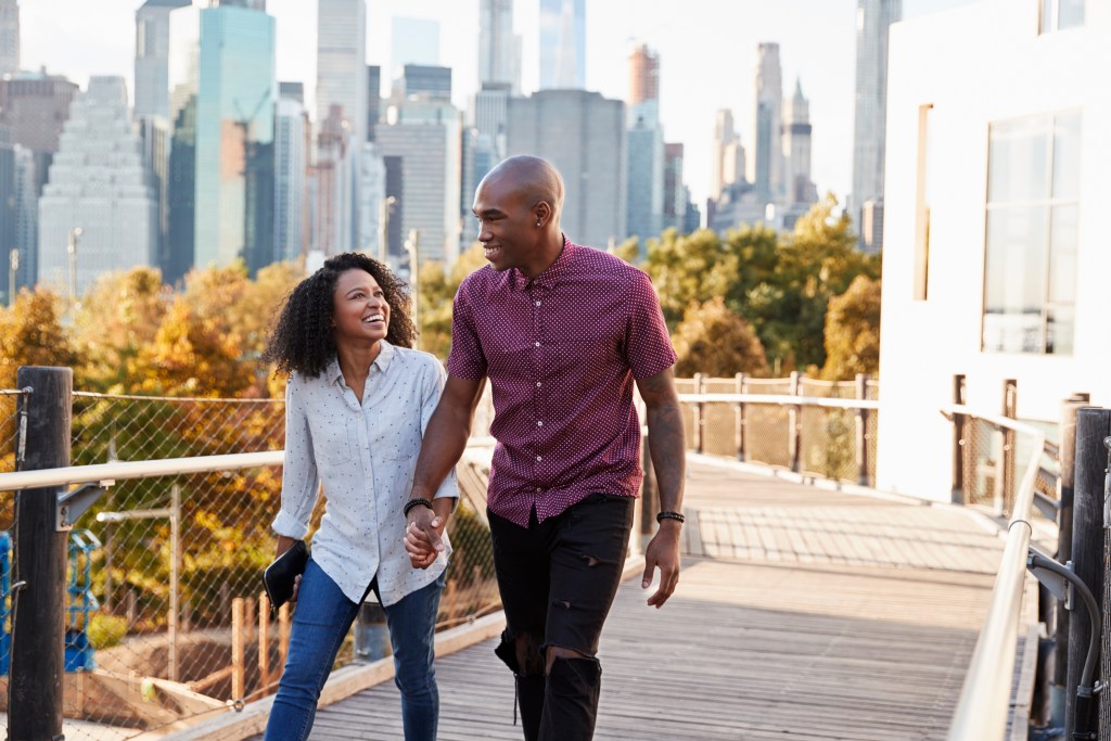 Enjoying urban forest canopy: couple walking in New York