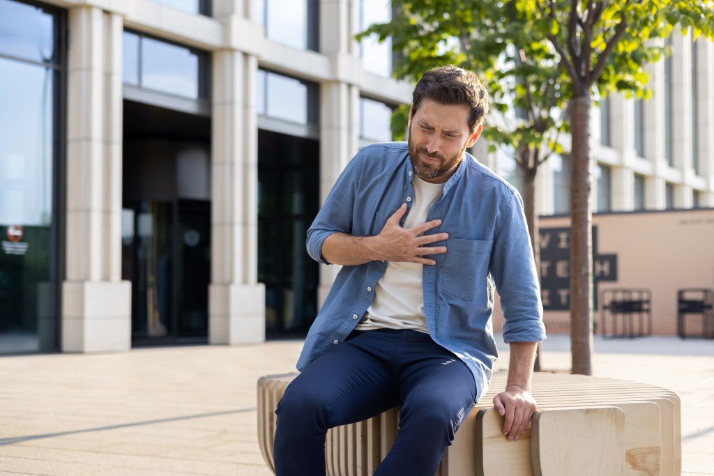 Urban forest canopy can help: man outside of office suffering a panic attack, stress