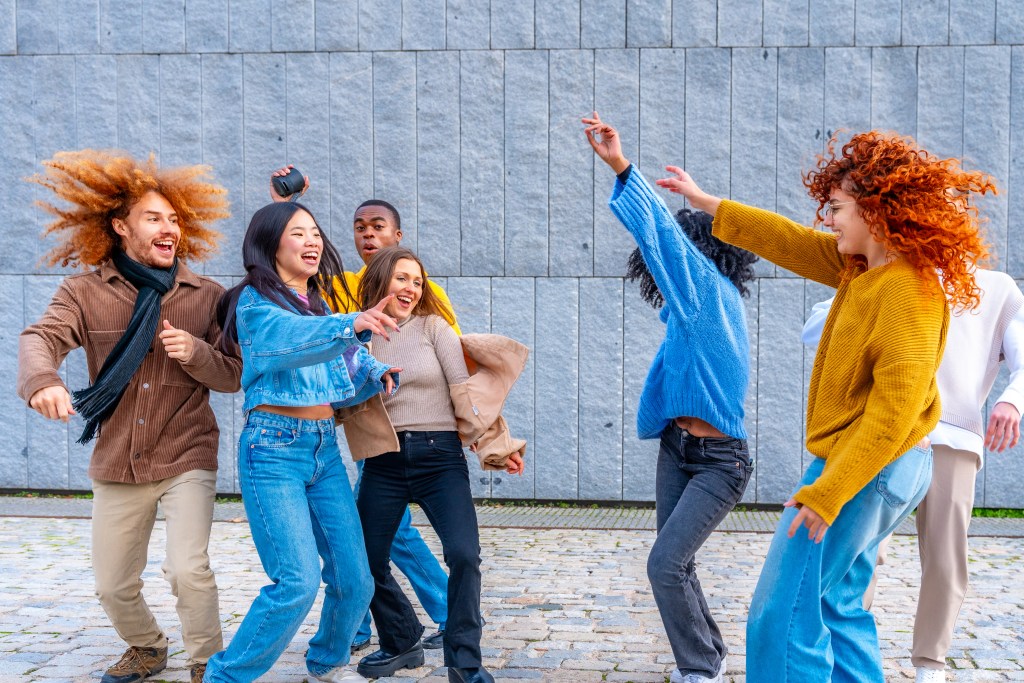 Dance it out: group of strangers moving to music in the street