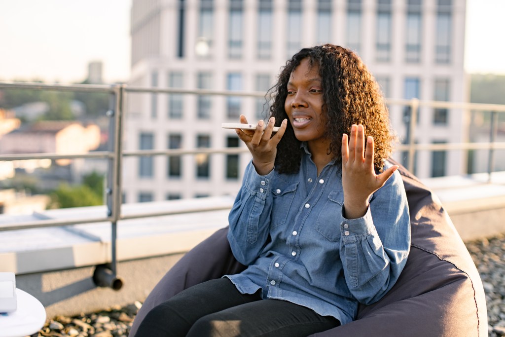 Woman speaking into her app, learning how to fix fearful avoidant attachment with the help of AI