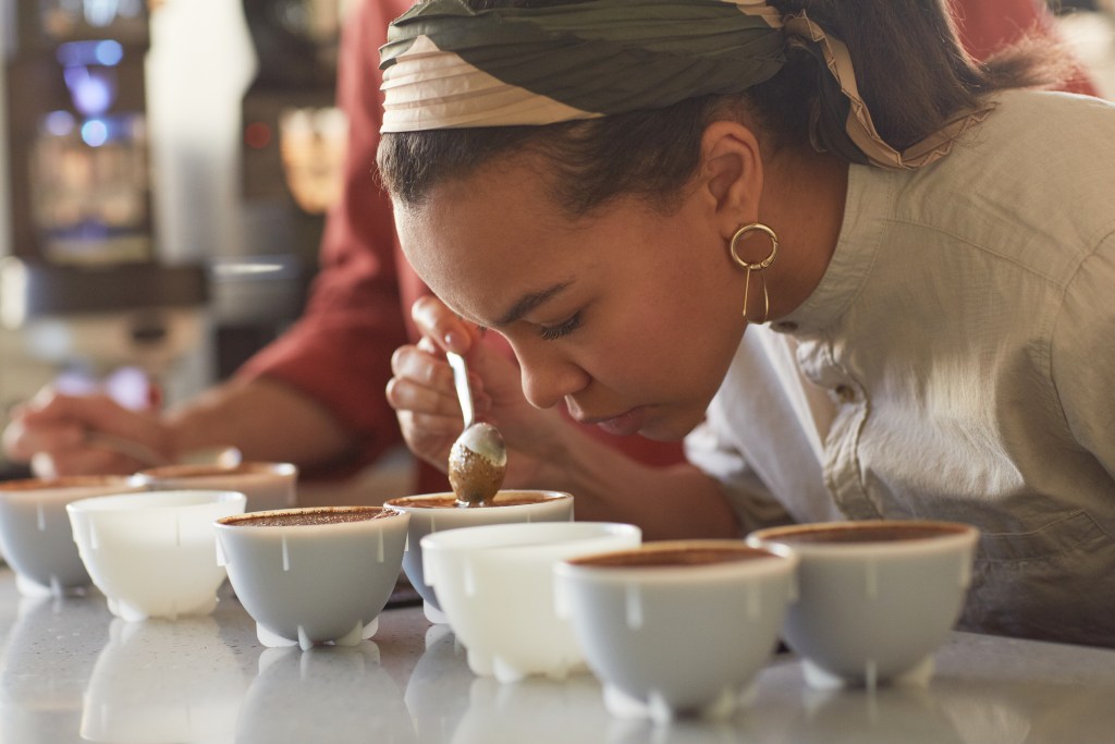 Woman smelling, tasting and testing ingredients for a cacao ceremony