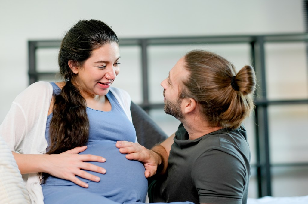 Pregnant woman getting support from her partner who encourages her with daily affirmations