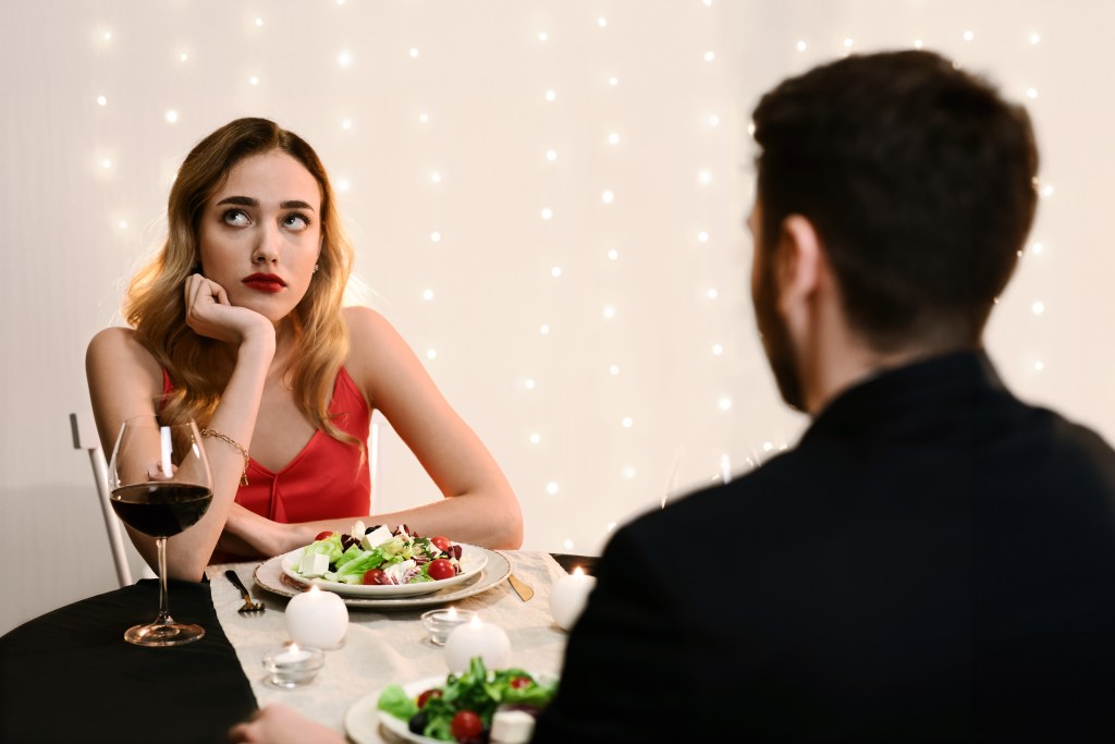 First date quotes gone wrong: woman looking bored and annoyed at restaurant