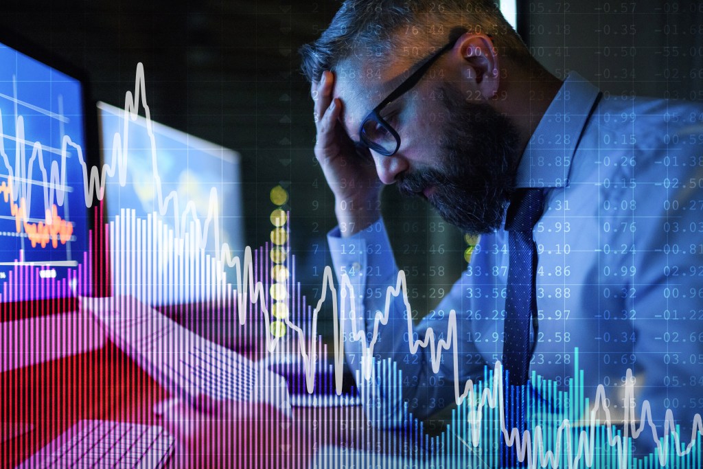 Dopamine hit: tired and wired businessman with computer pulling all-nighter