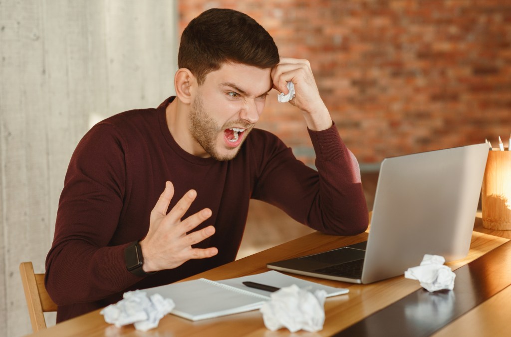 Male creator feeling angry at himself for not being productive due to email anxiety