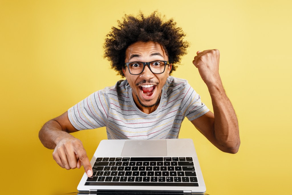 Hitting send: Excited man who has successfully overcome email anxiety