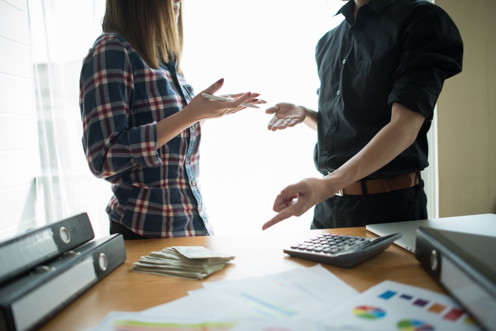 Healthy issues and financial abuse in relationships can look similar: couple debating money