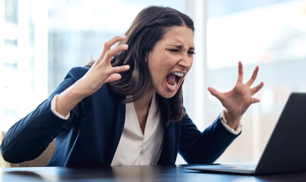 Inspirational quotes for women: Overwhelmed professional screaming at her laptop