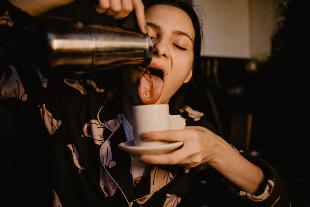 Functional beverages? A woman drinking coffee from cezve to fight tiredness.
