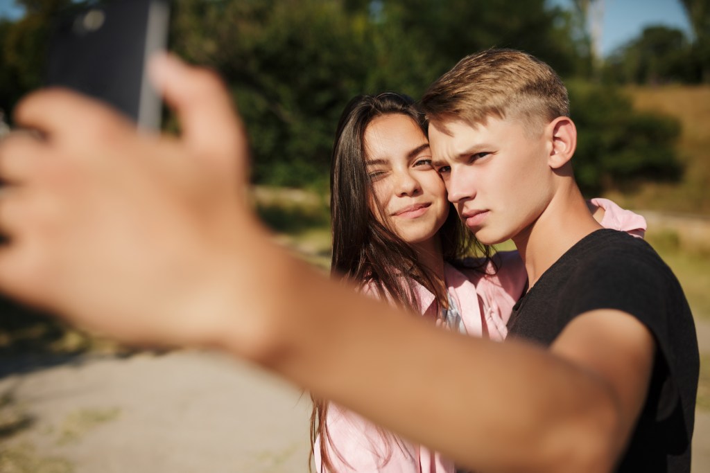 Am I dating someone with BPD? Young couple taking a selfie, looking critical
