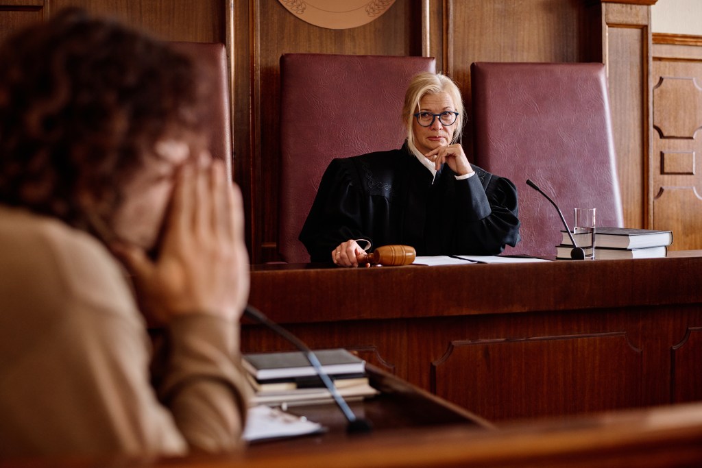 Portrait of female judge and stressed plaintiff in a lawsuit, tense situation