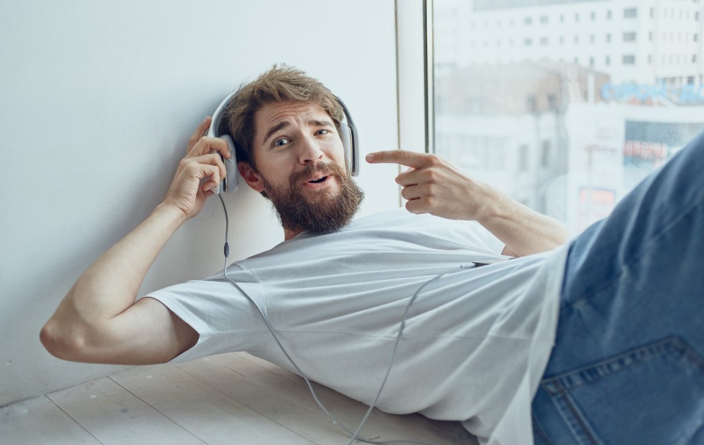 Man mistaking binaural beats via headphones for music therapy and brain hacks