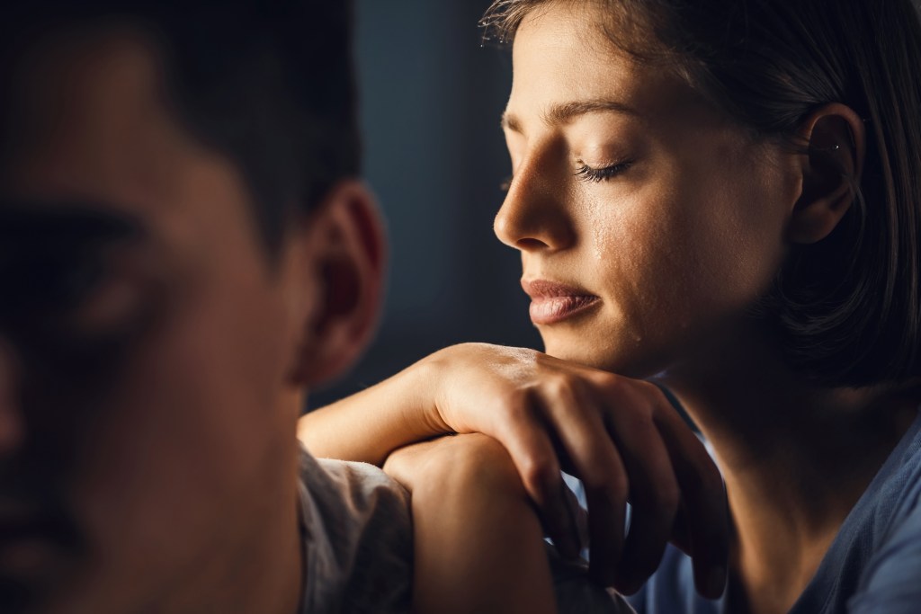 Depression: Sad Woman with Tearful Emotions Leans on Man