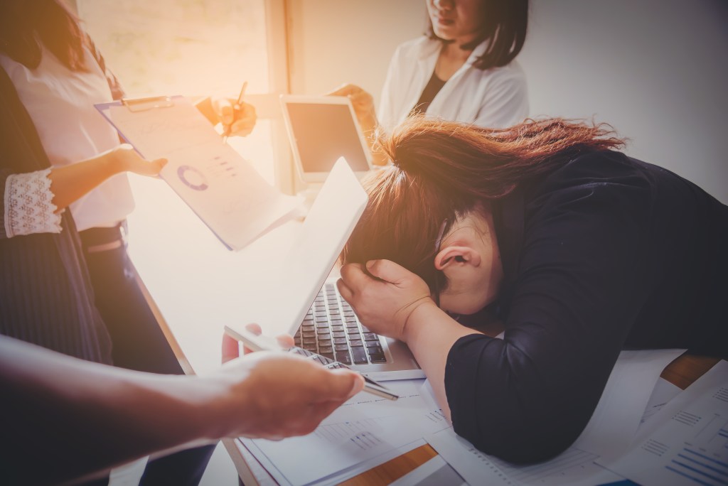 Woman struggling with chronic stress at work thinking about a multi-day mental health retreat 